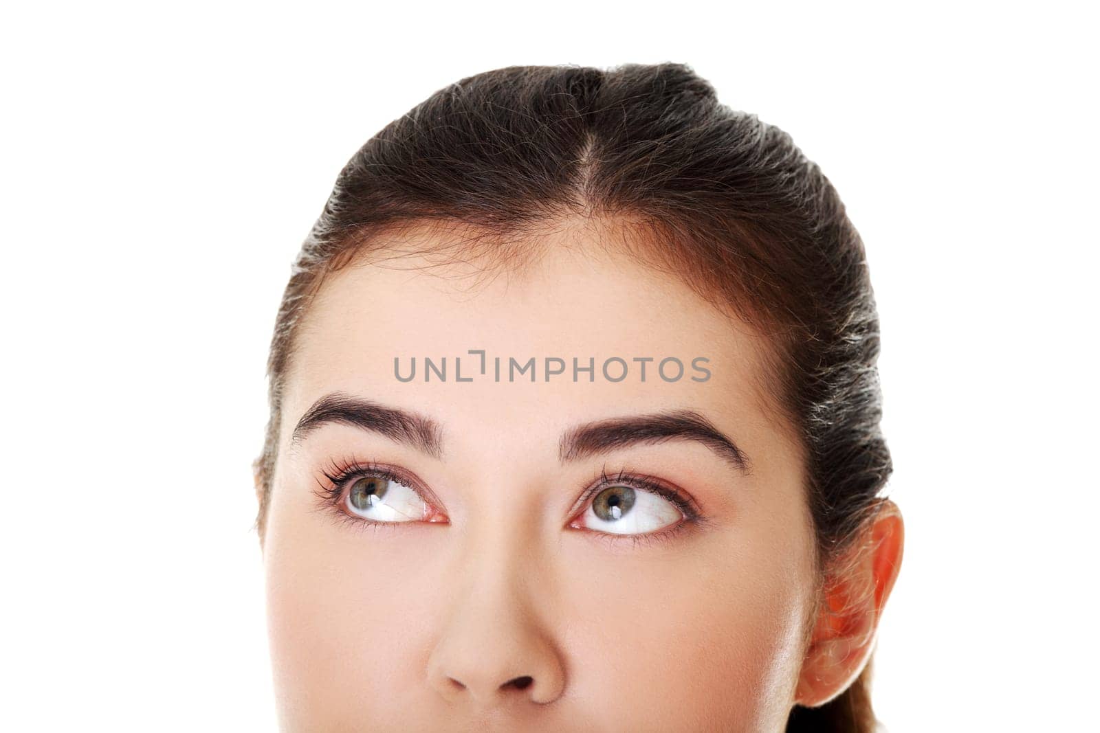 Thoughtful female student looking up, isolated on white