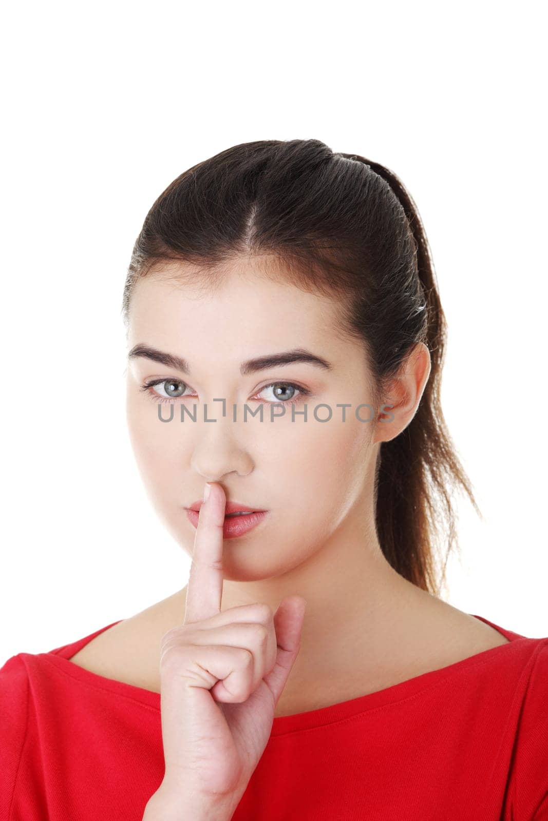 Attractive woman making a keep it quiet gesture , isolated on white