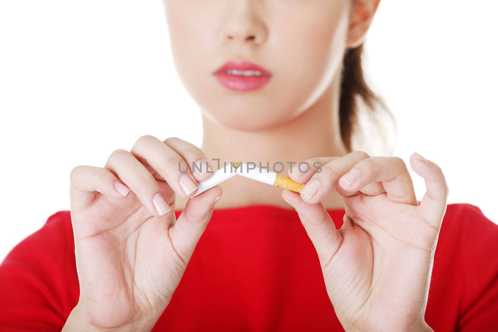 Young woman with broken cigarette. Stop smoking concept.