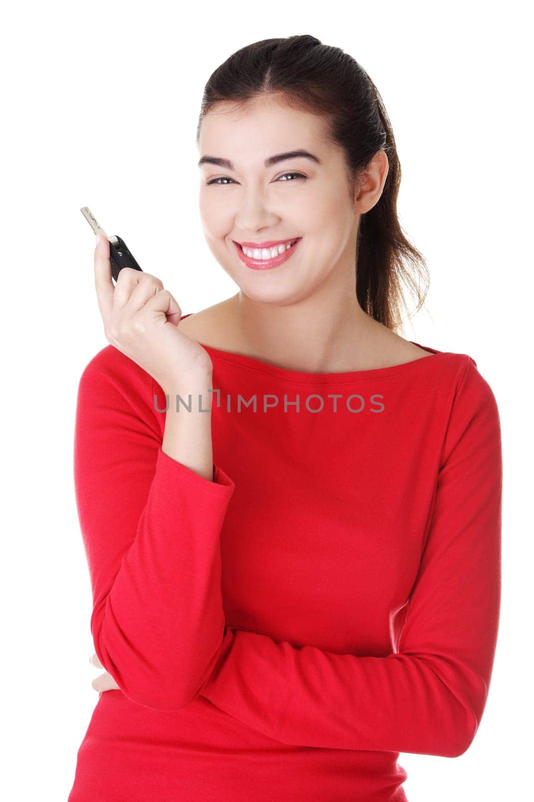 Happy woman with a car key. Isolated on white.