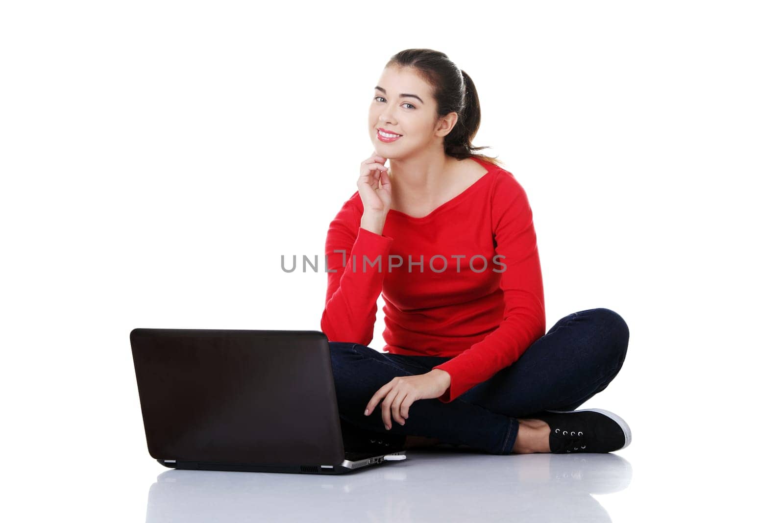 Happy young woman using her laptop, isolated on white.