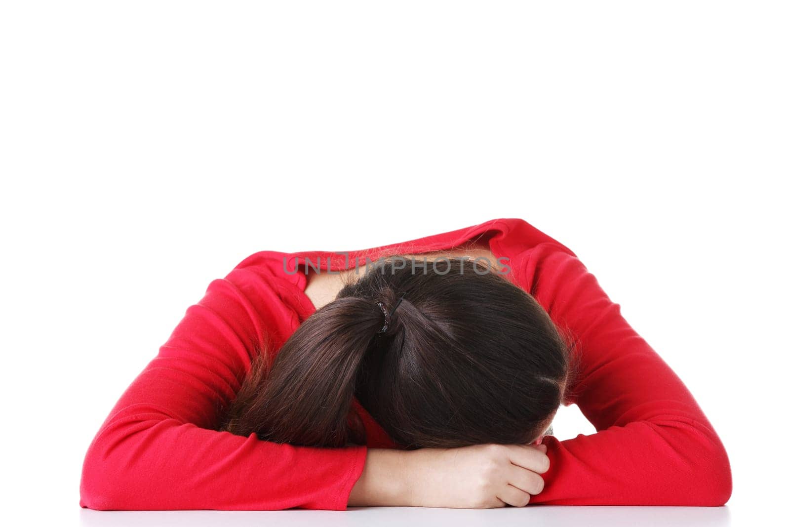 Young woman sleeping on desk, isolated on white