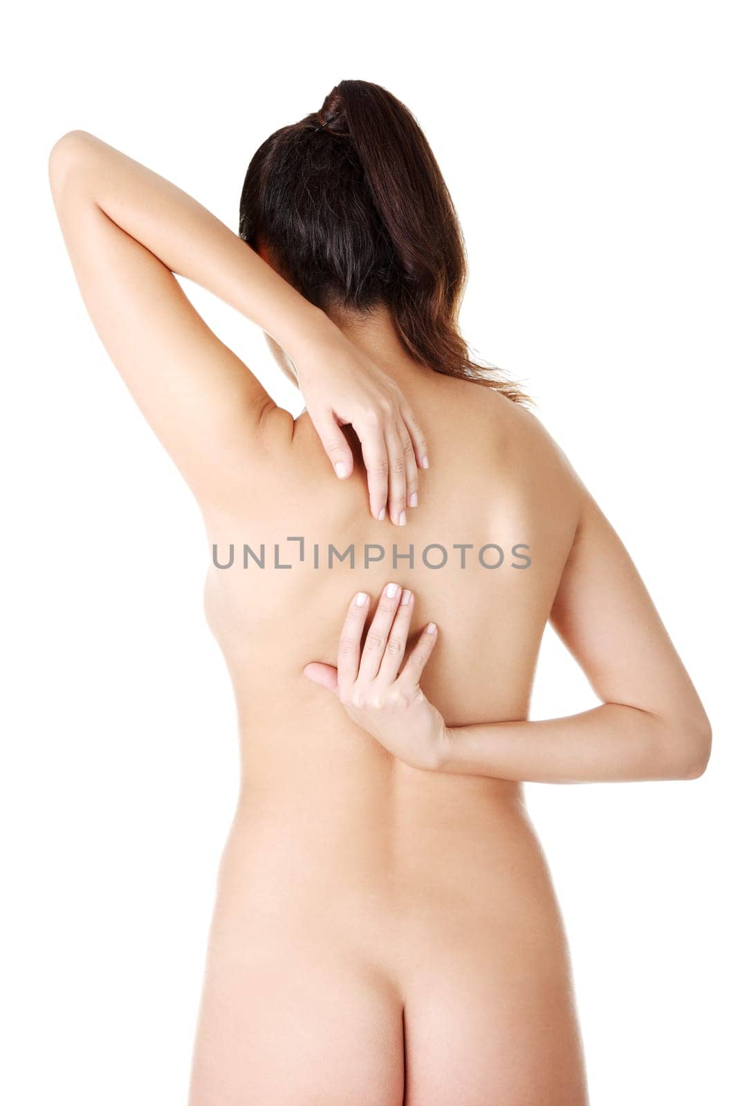 Young woman with pain in her back. Isolated