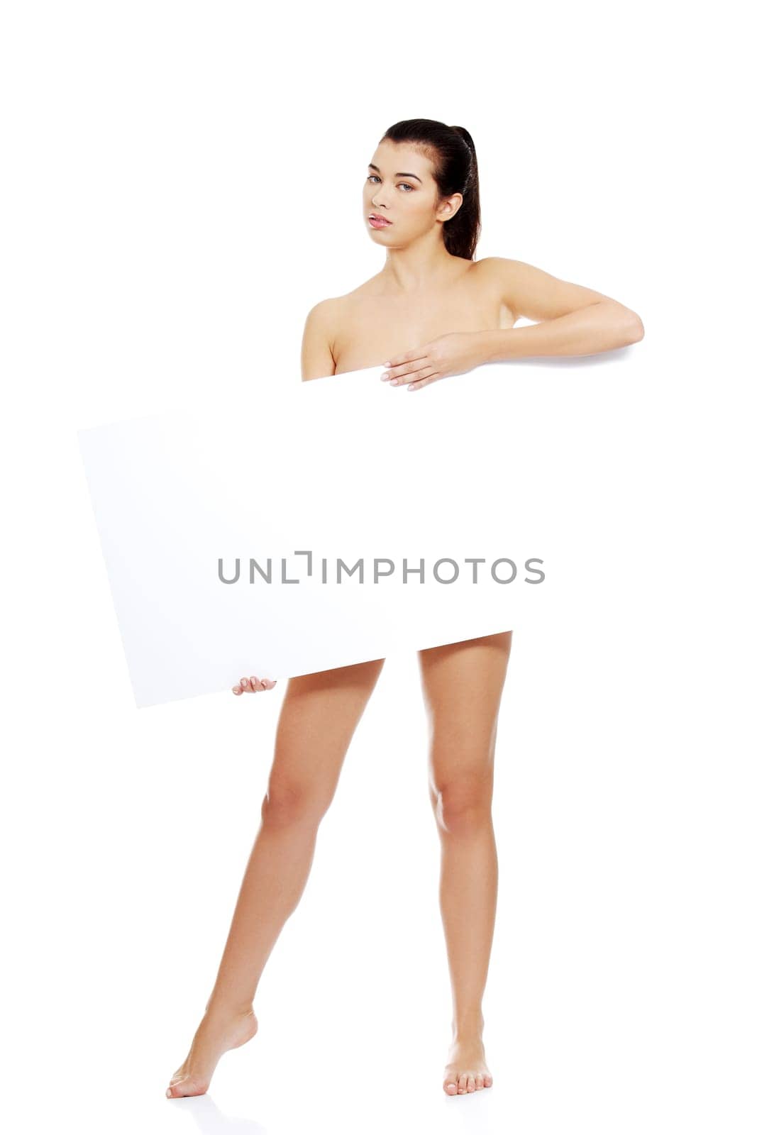 Sexy naked brunette holding empty board , isolated on white.