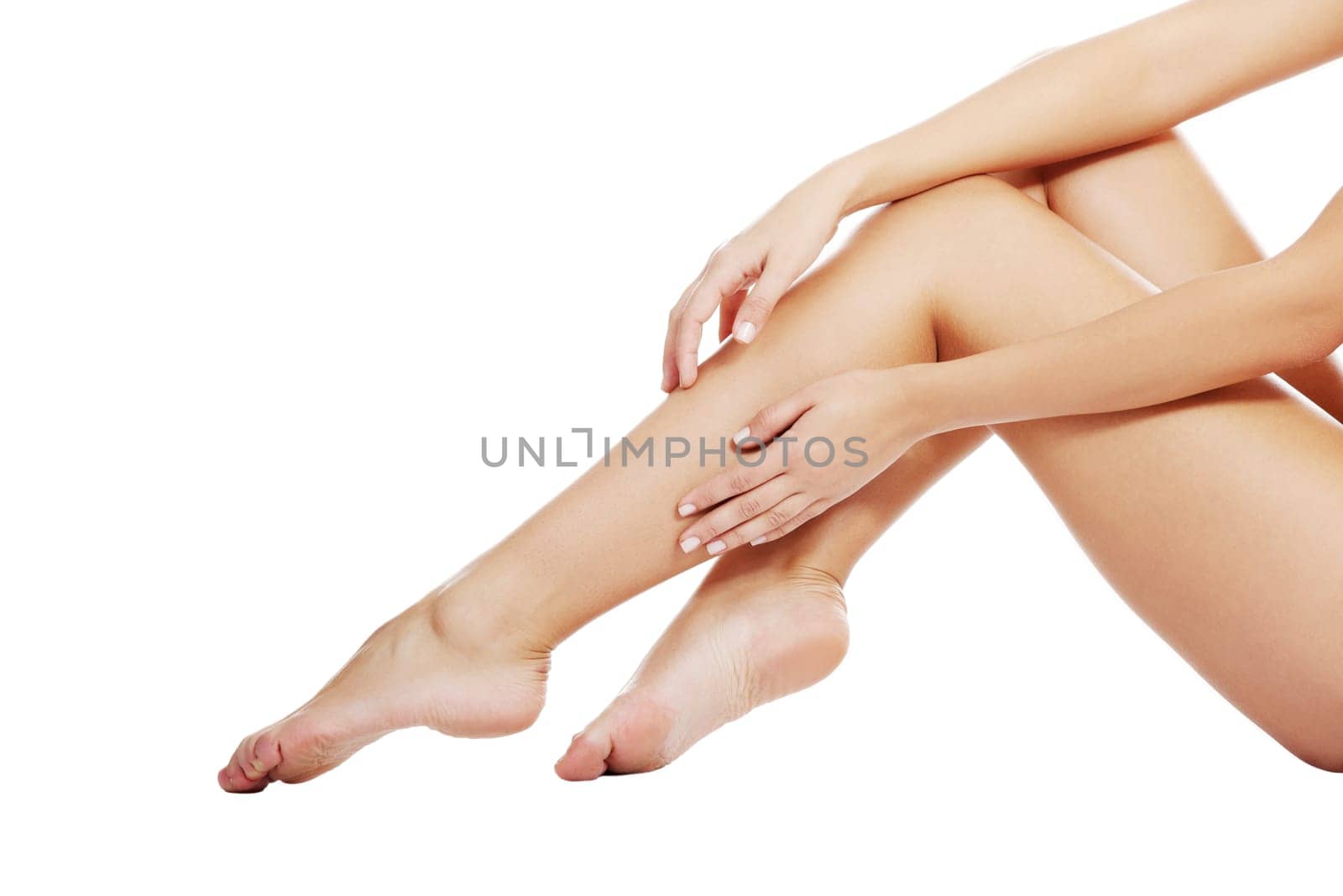 Beautiful female legs touched by hand , isolated on white