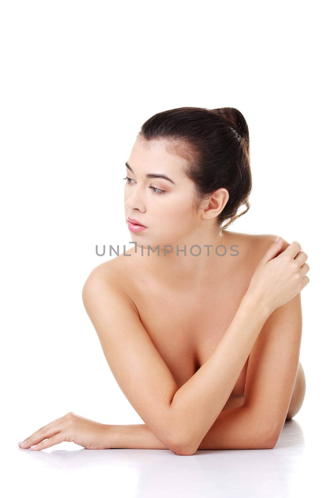Sexy fit naked woman with healthy clean skin lying down, isolated on white