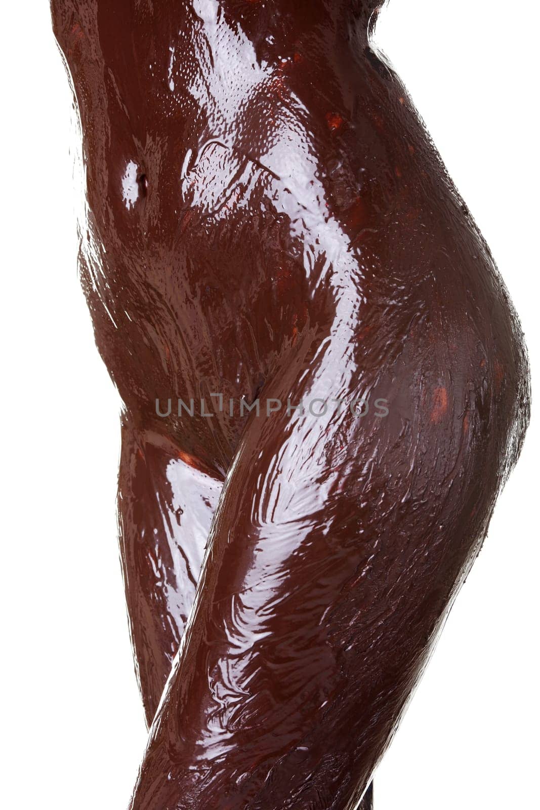 Naked female body covered with chocolate, isolated on white