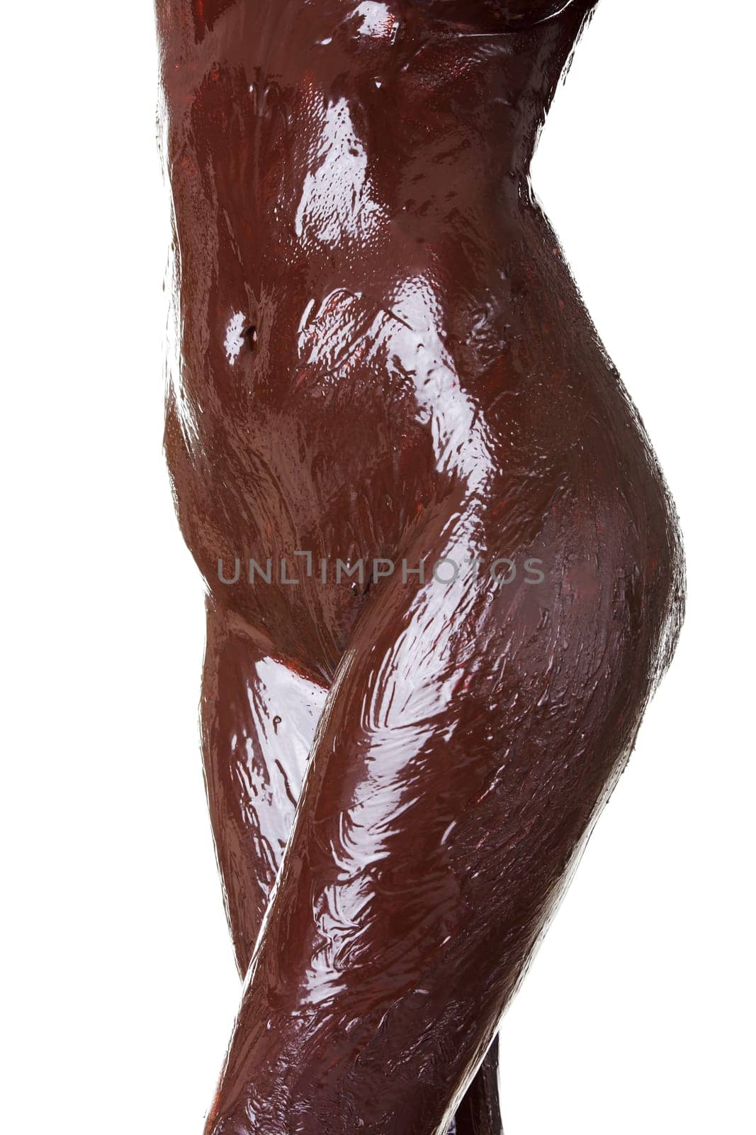 Naked female body covered with chocolate, isolated on white