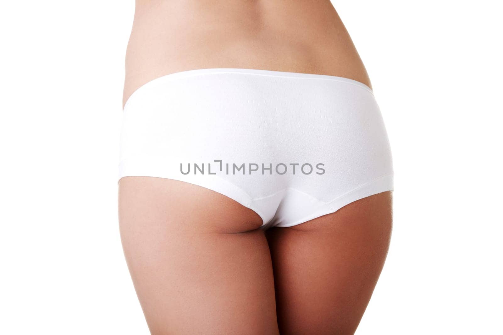Slim tanned woman's body. Isolated over white background.