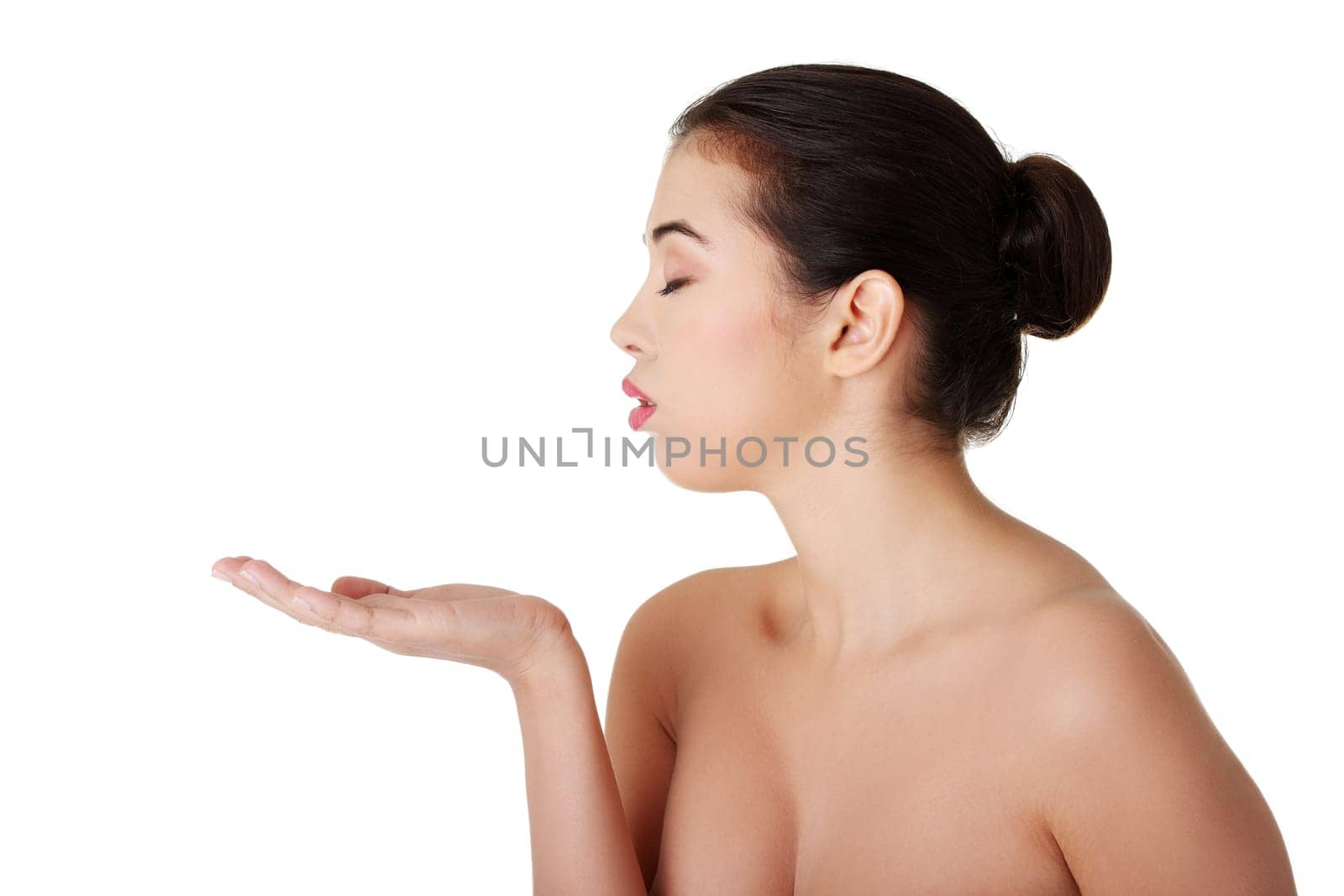 Attractive woman with clean fresh skin presenting copy space on her palm