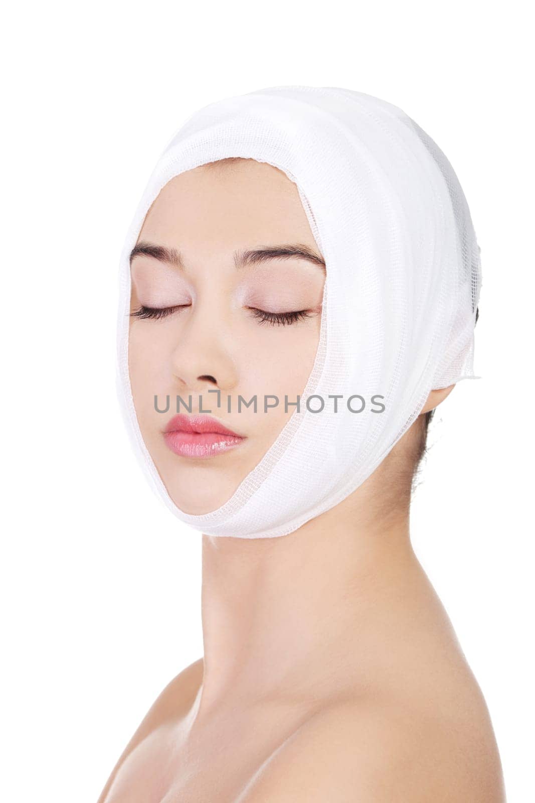 Portrait of beautiful young female face with bandage - beauty treatment plastic surgery