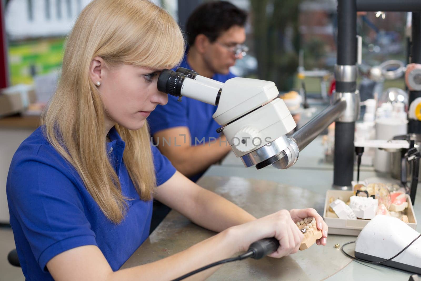 Dental technician at work in a dental laboratory or dental workshop