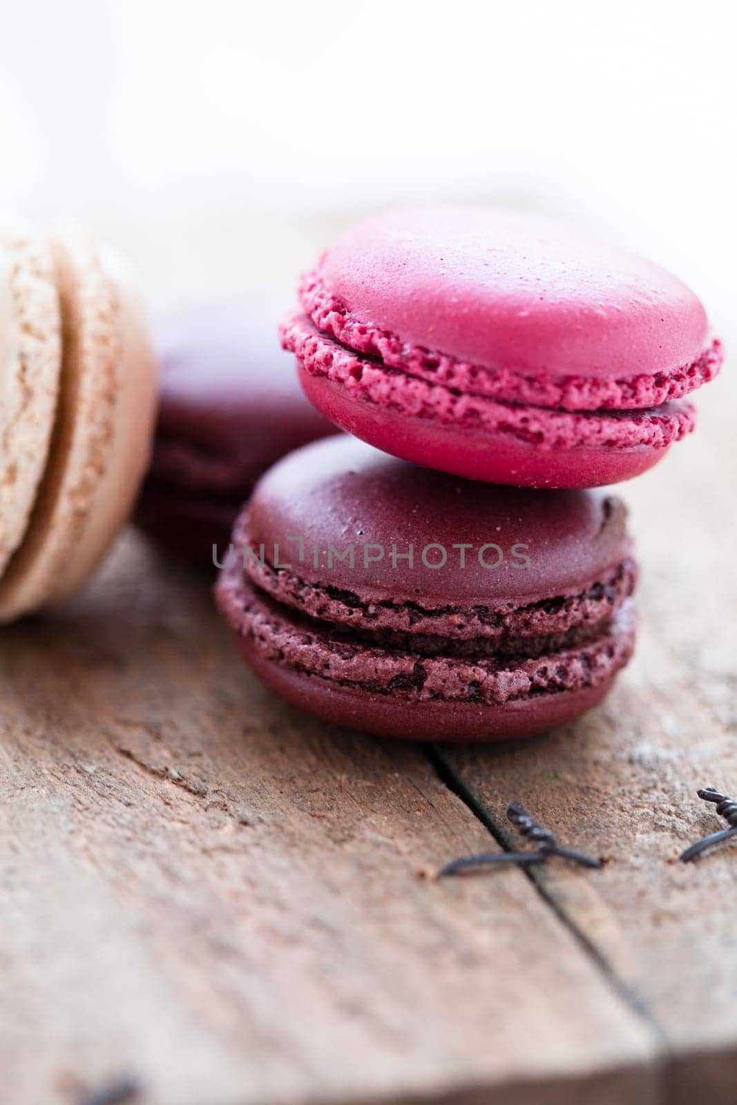 Closeup of four different flavoured macaroons on wooden table