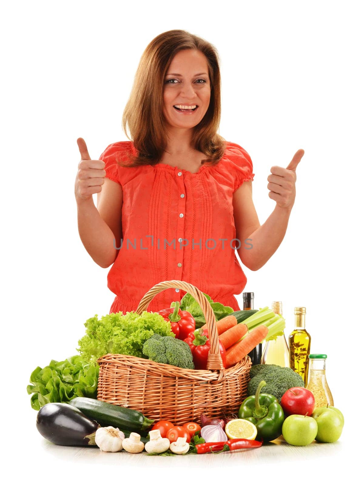 Young woman with variety of vegetables isolated on white background