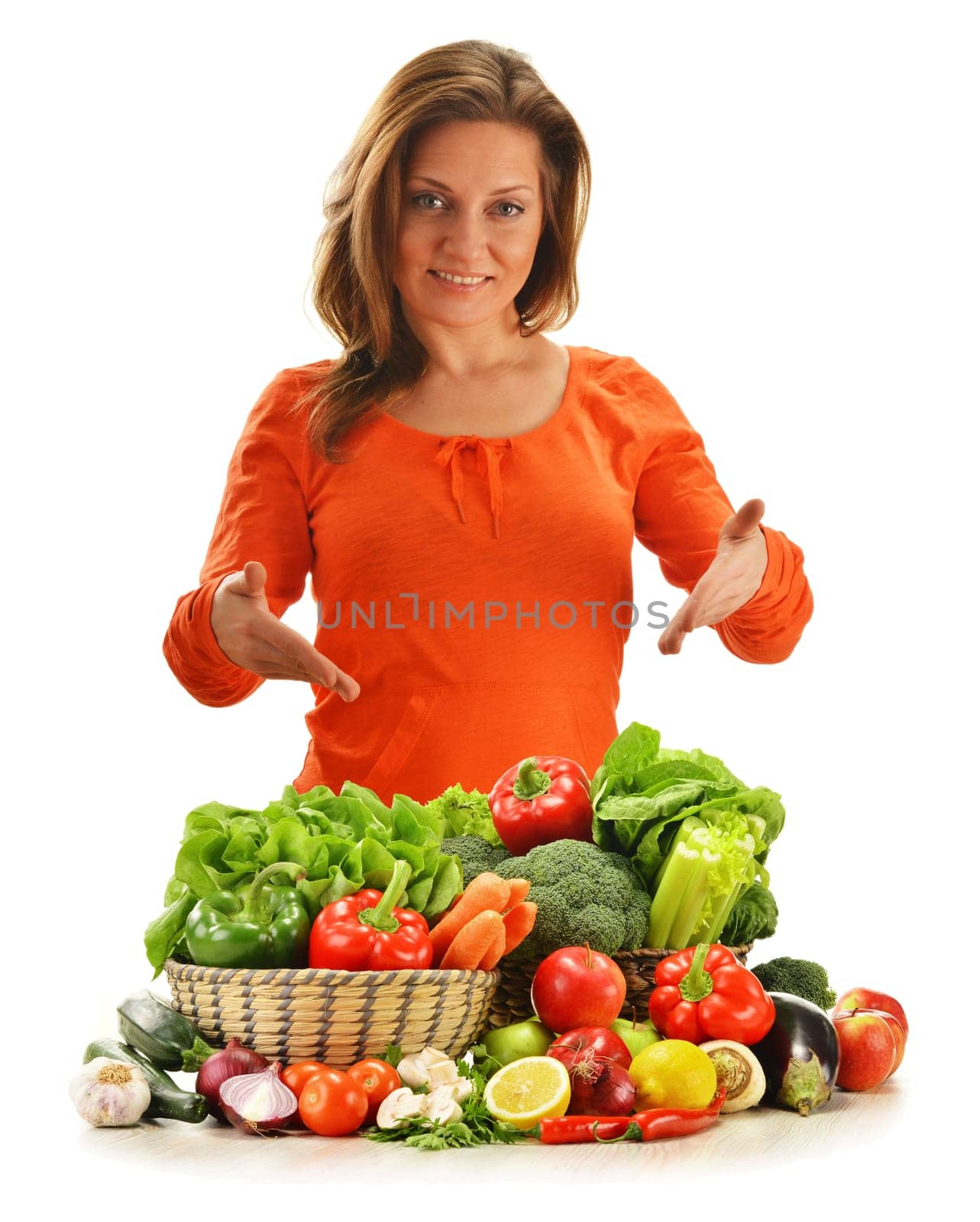 Young woman with variety of vegetables isolated on white background