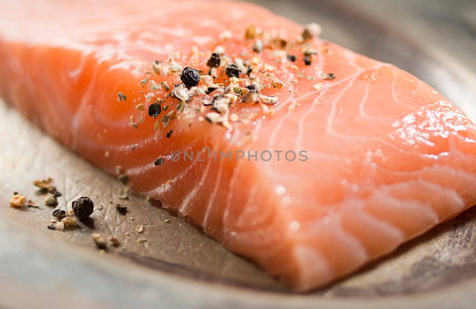 Raw salmon fillet on a plate close up