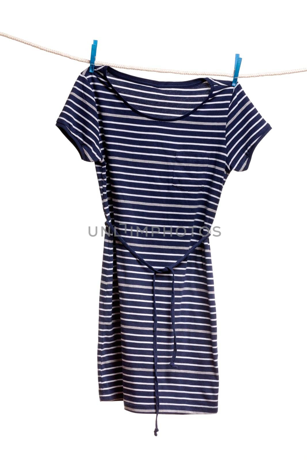Women's striped dress hanging on a rope with clothespins. Isolate on white.