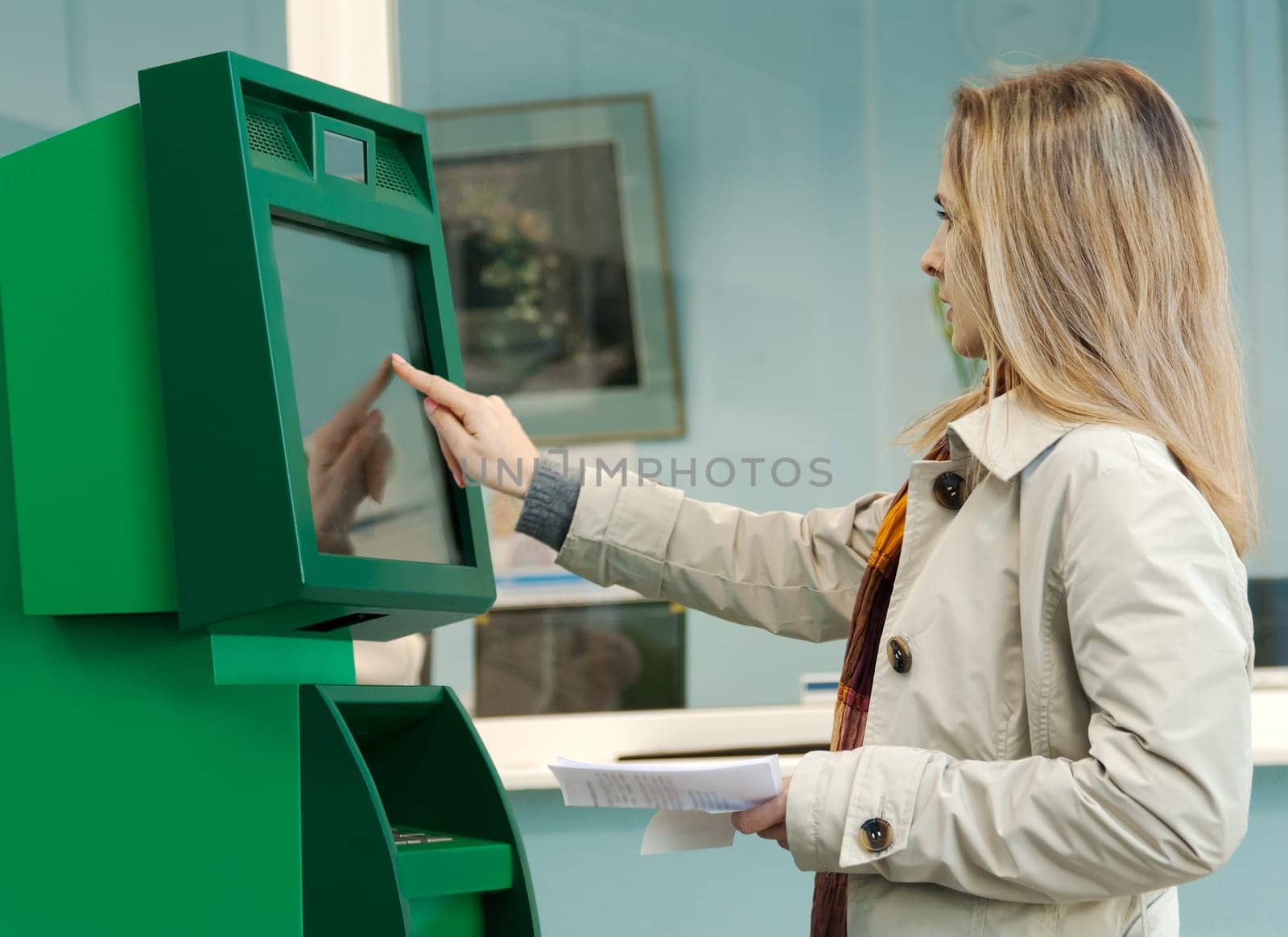 Girl pays the utility bills via ATM