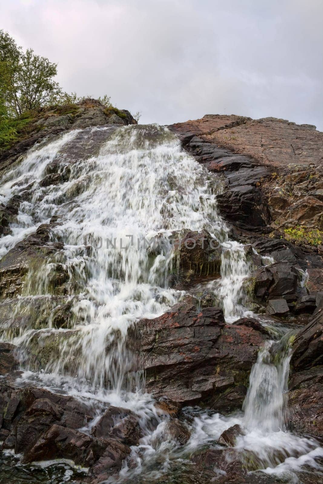 closeup of water flowing over falls, time exposure
