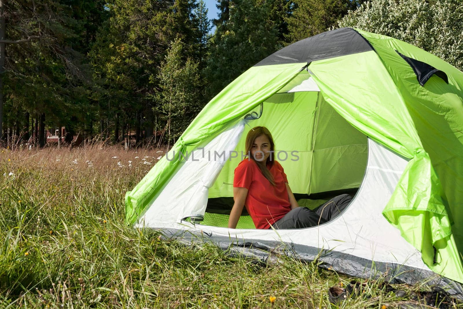 Young beautiful girl in a tent in a forest