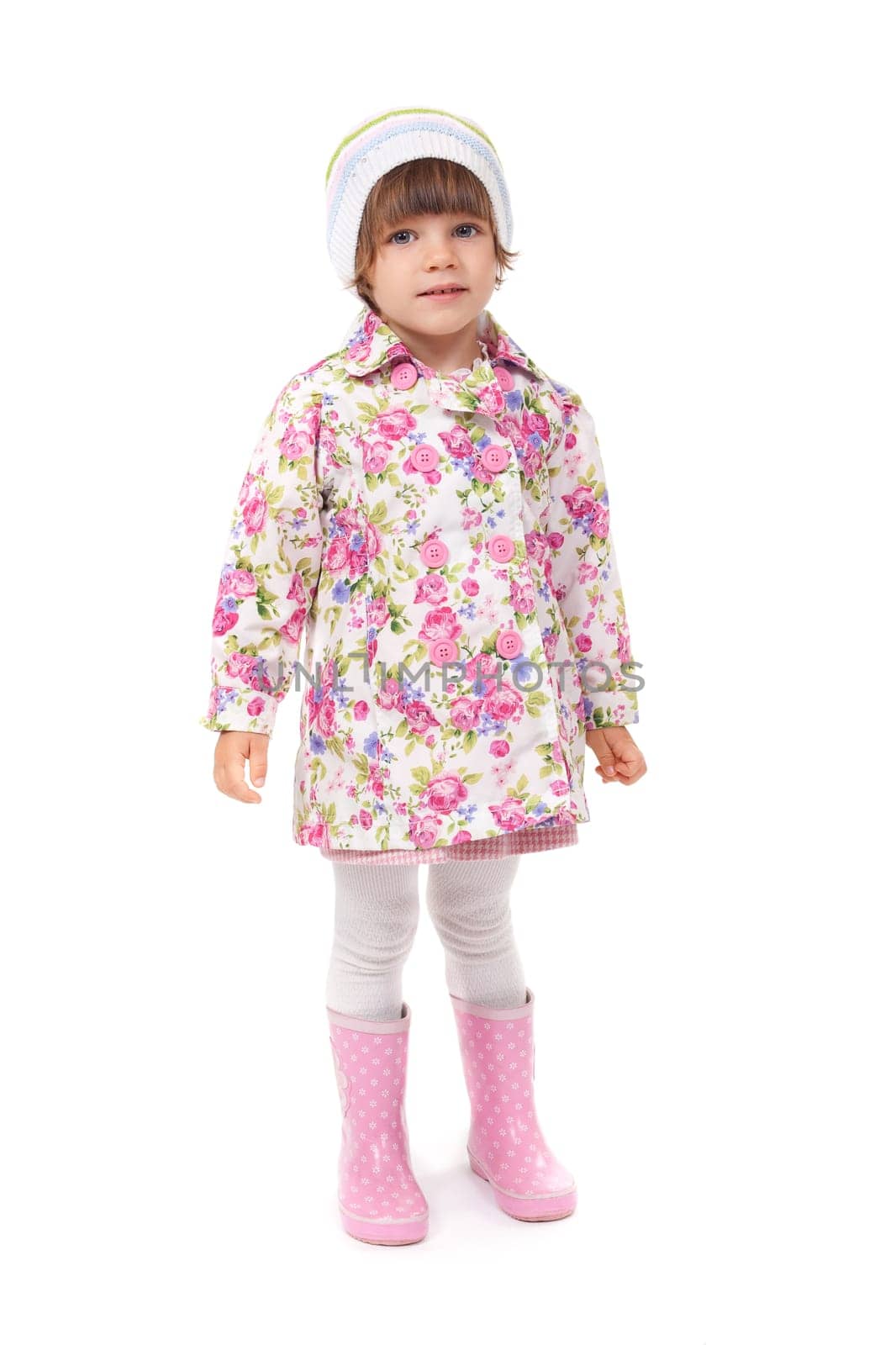 little girl in boots and a jacket in the studio. Isolate on white