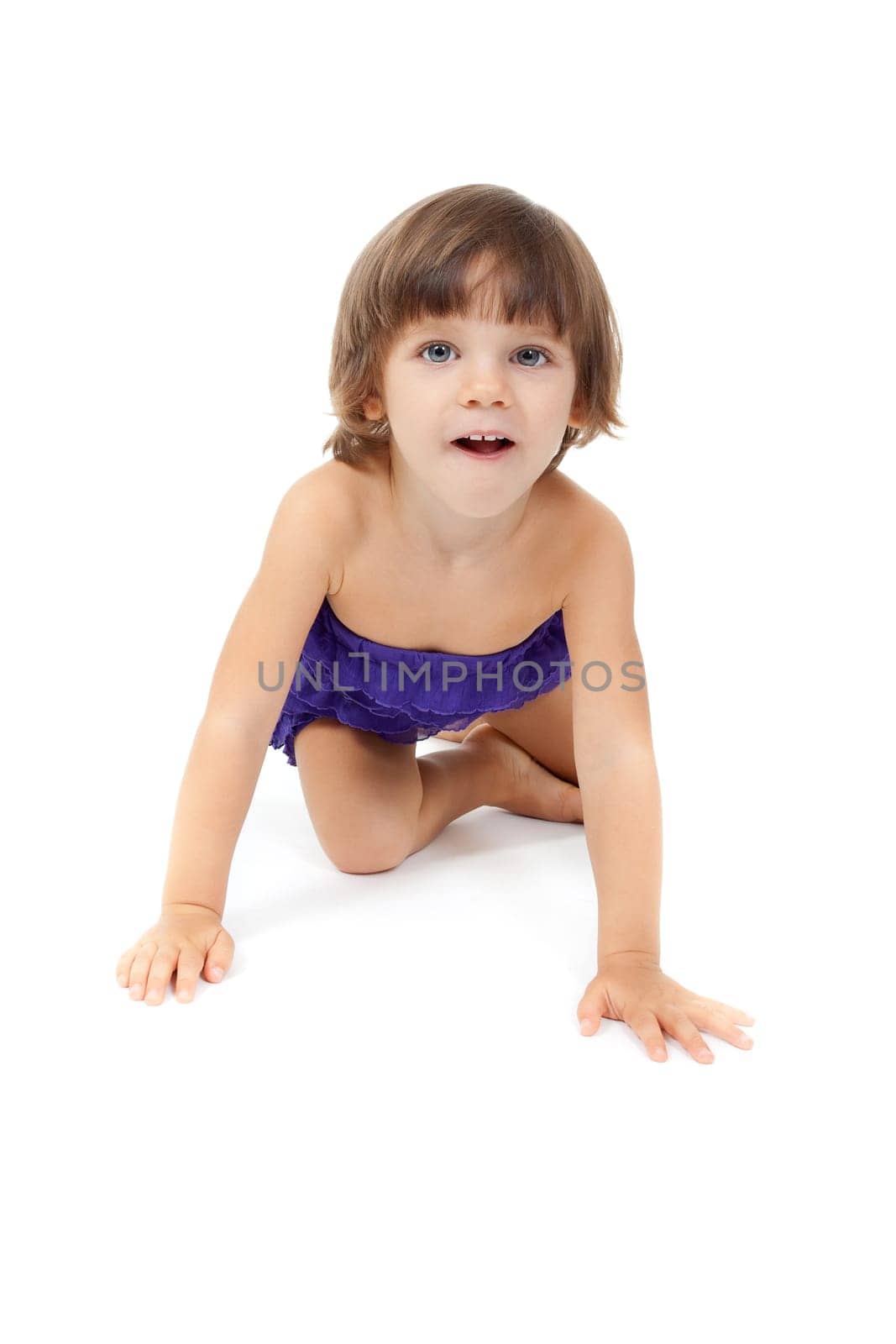 Little girl four years old crawling on the floor. Isolate on white.