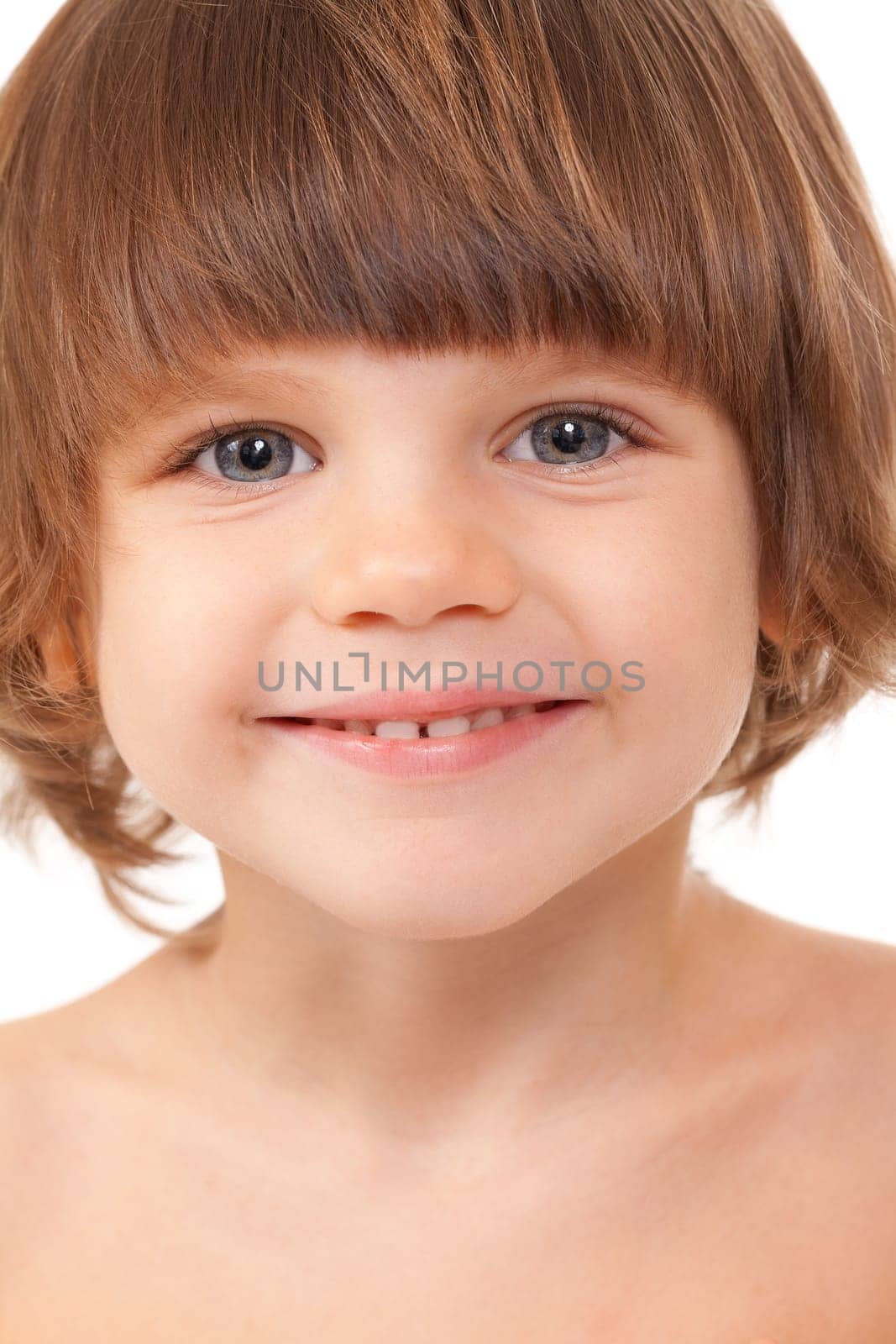 Close-up portrait of the girl child in the studio. Isolate on white.