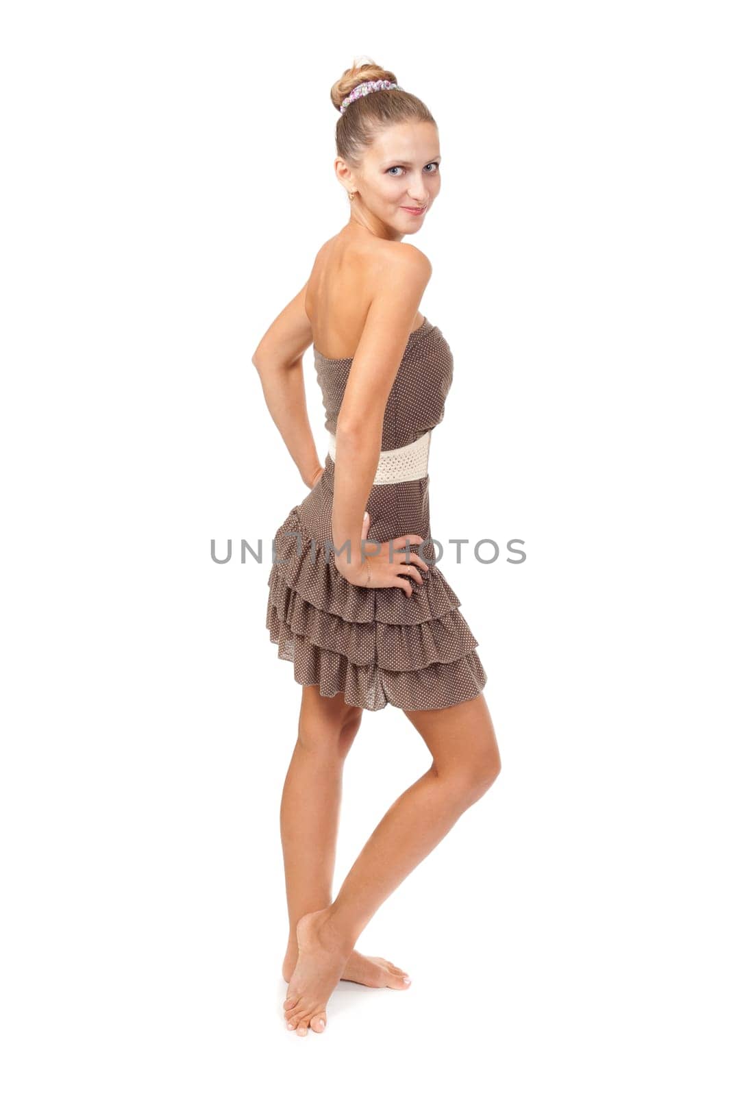 Portrait of the beautiful young girl in a beige dress with the long bared feet. Isolate on white.