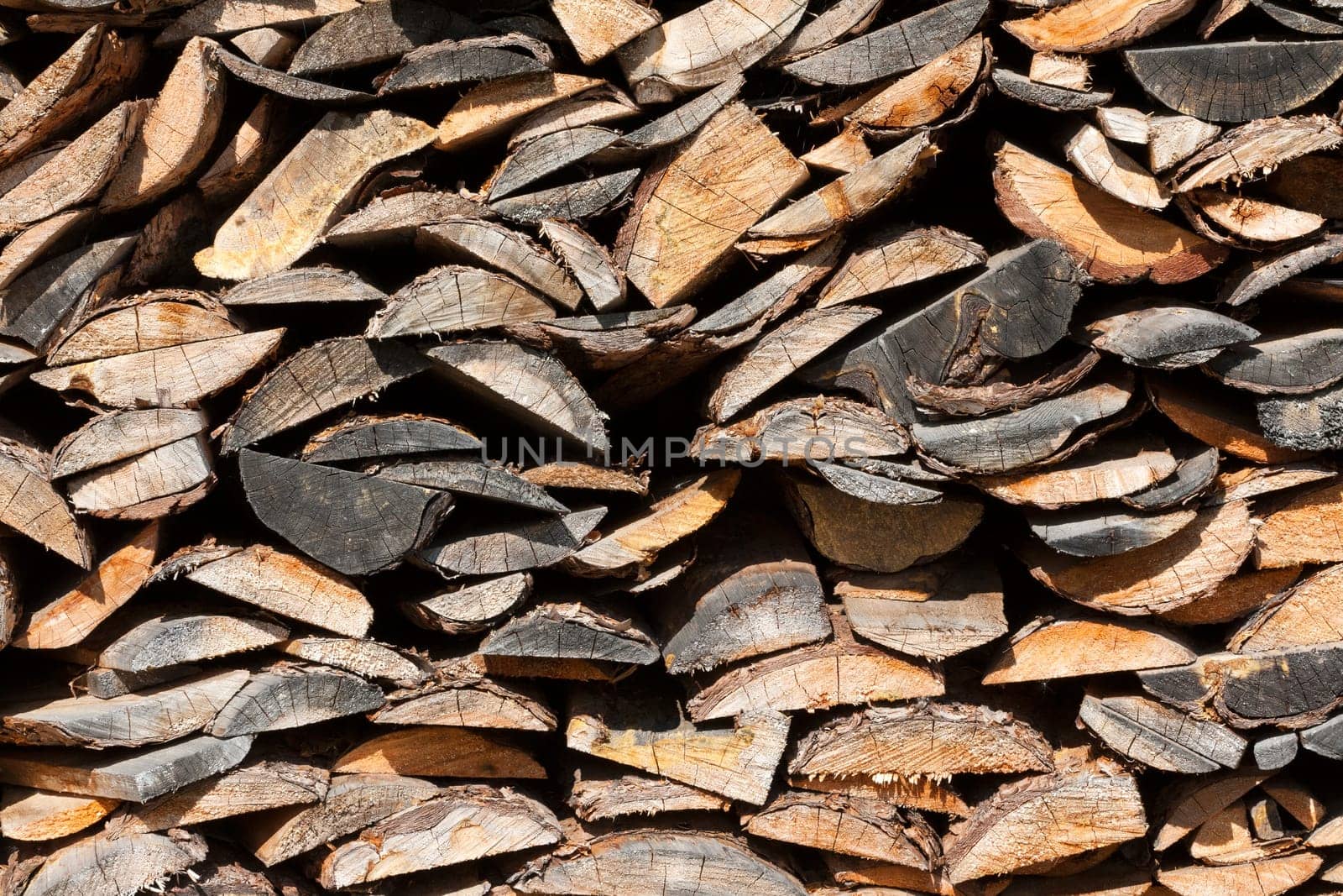 Background of dry chopped firewood logs in a pile