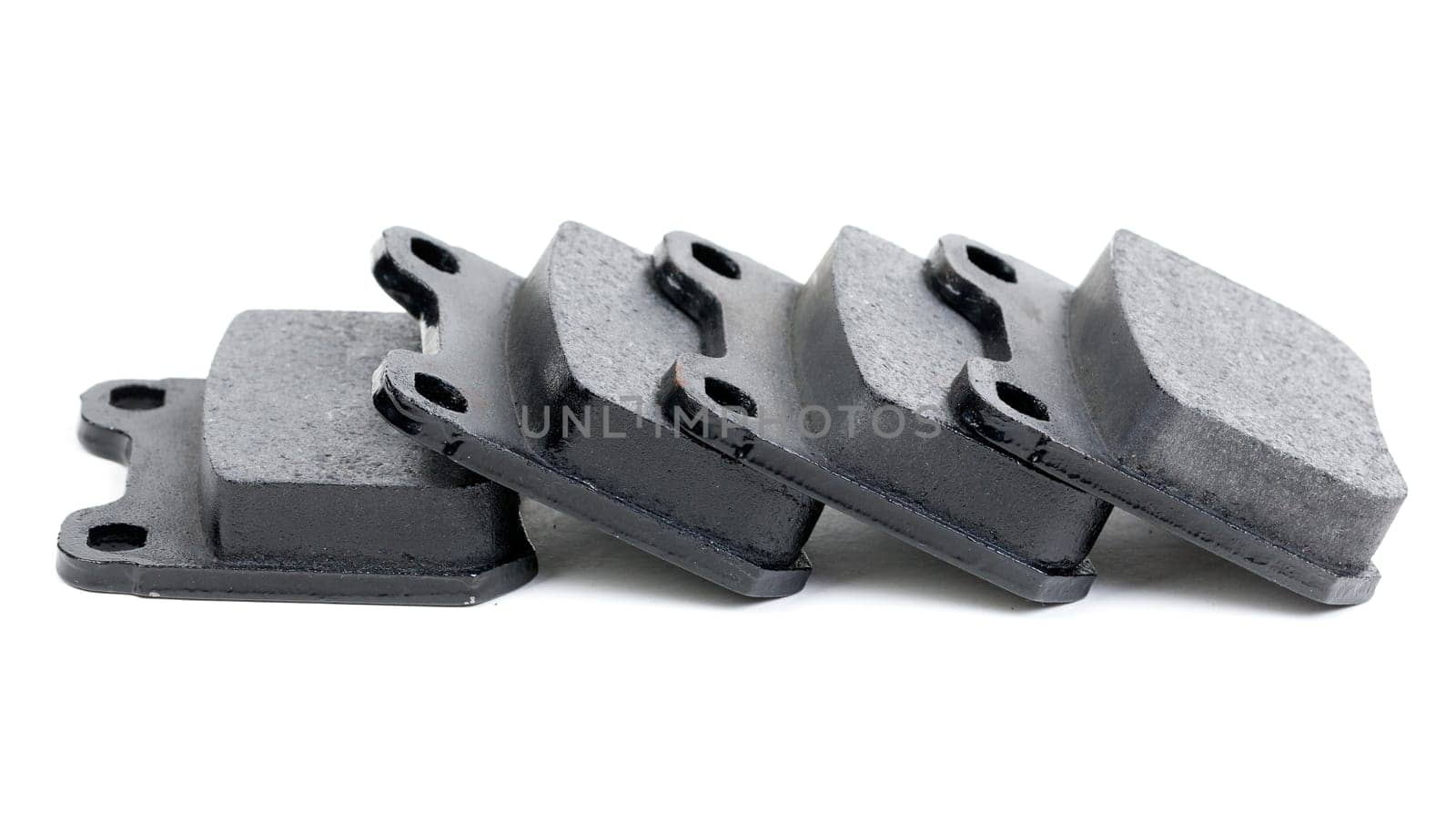 Four clean isolated disc brake pads. Isolate on white.