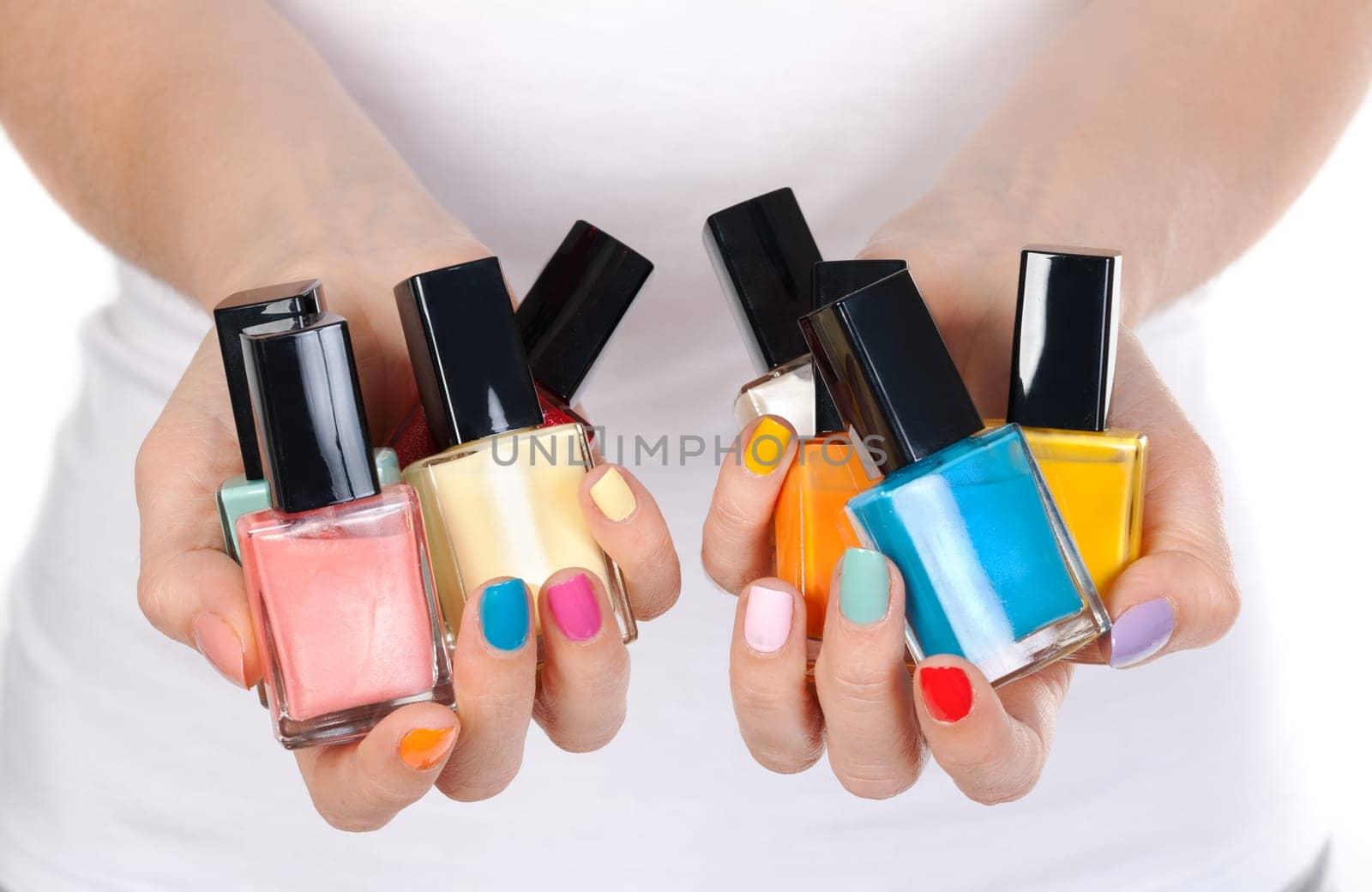 woman hand holding colorful nail-polish