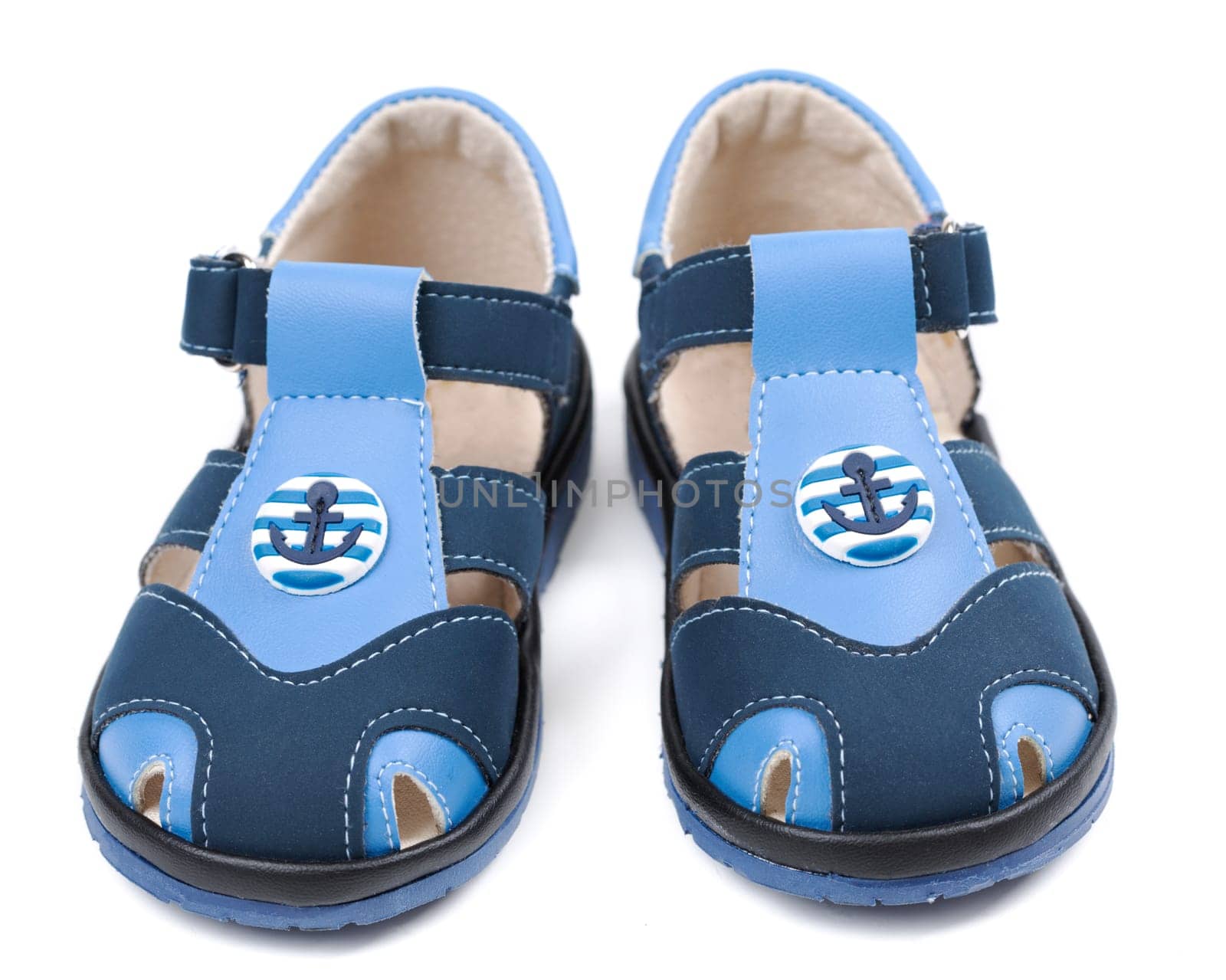 Baby blue sandals with a pattern in the shape of an anchor. Isolated on white background.