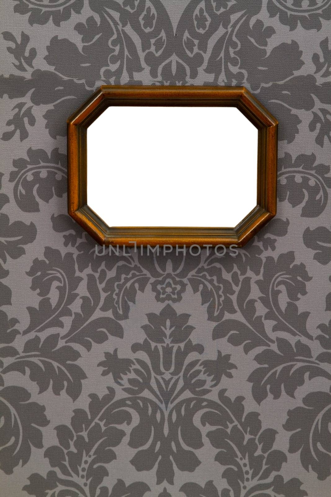 Empty picture frame on floral wallpaper