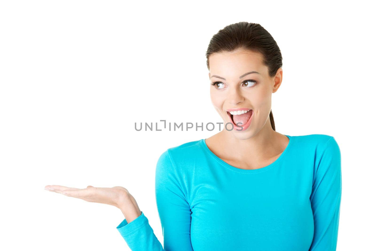 Happy , excited young woman presenting copy space on her palm, isolated on white
