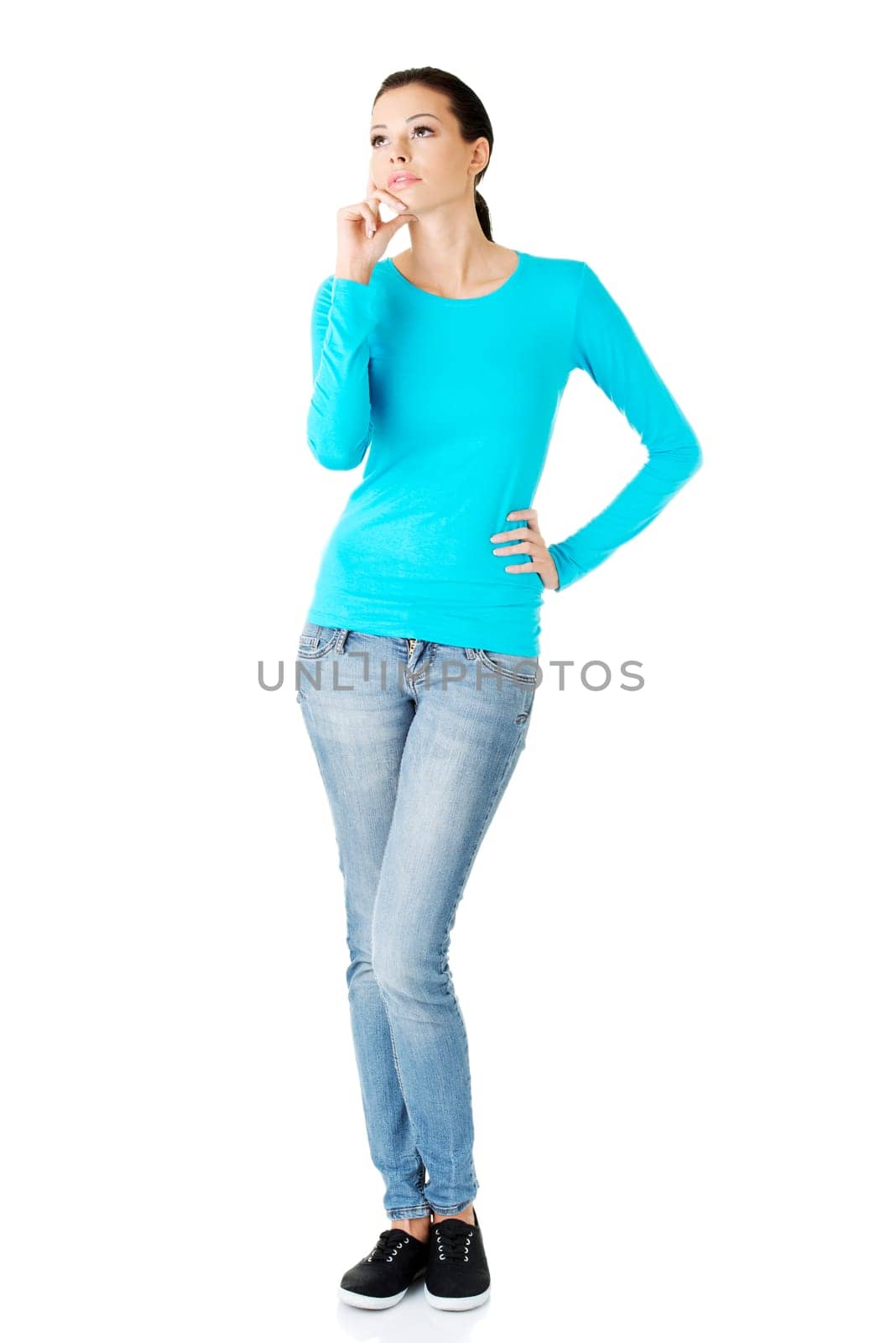 Thoughtful female student looking up, isolated on white