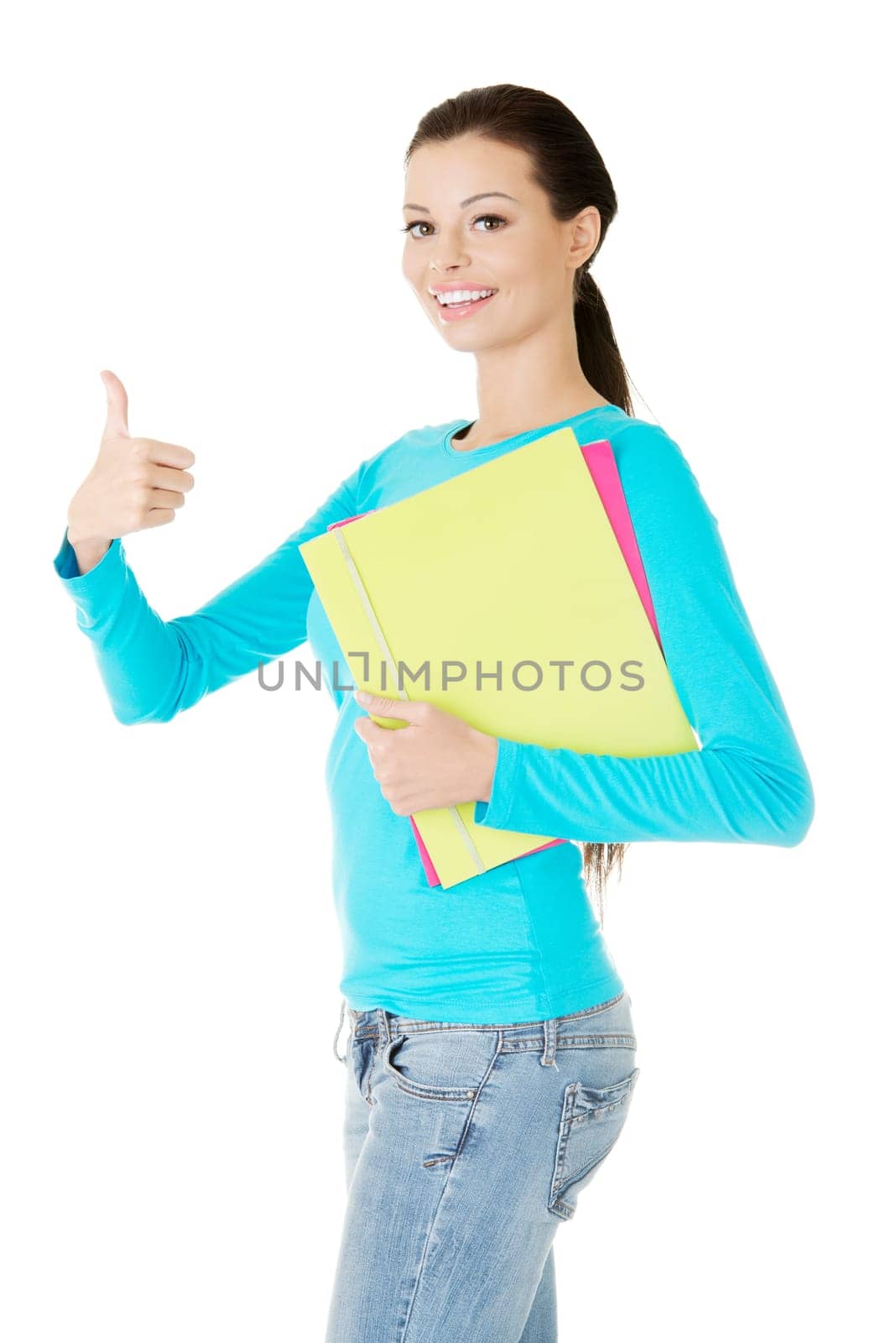 Beautiful young student woman gesturing OK.