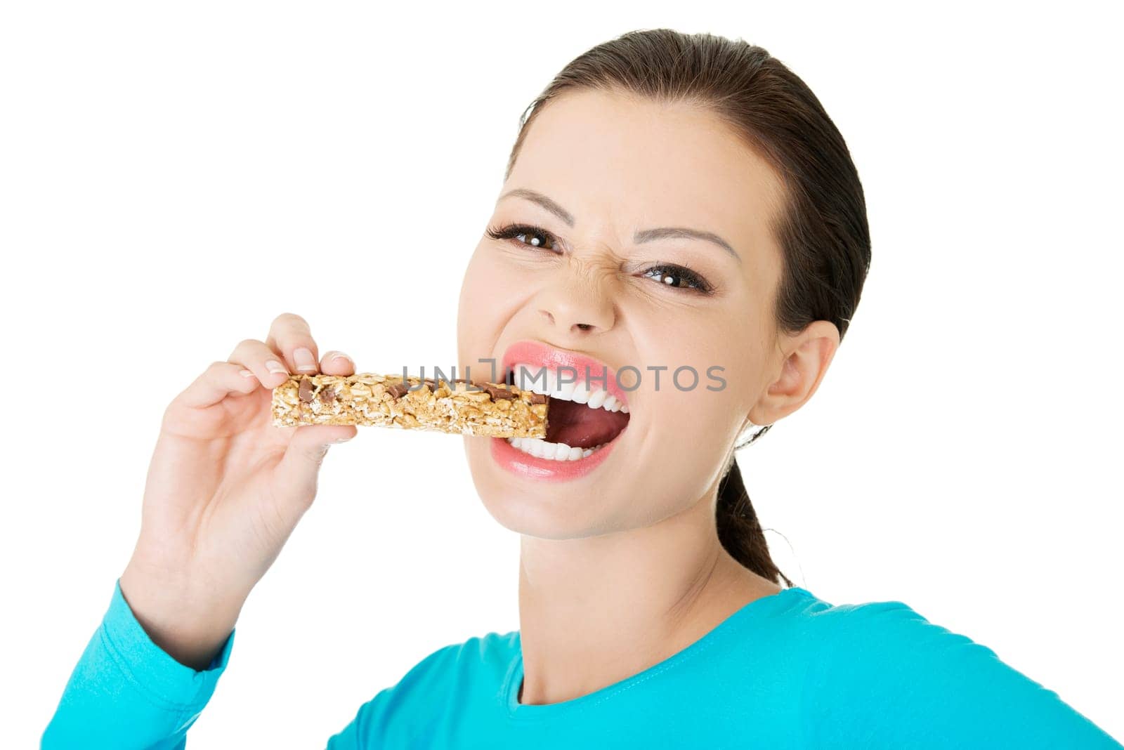 Young woman eating Cereal candy bar, isolated on white
