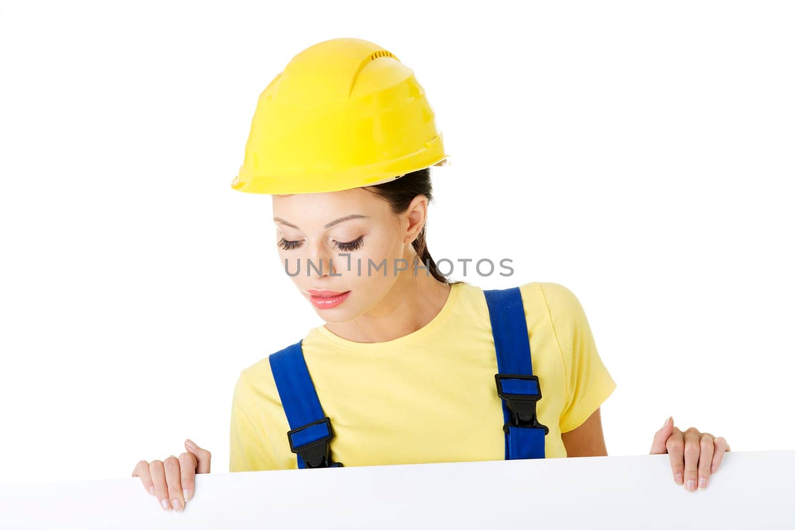 Female construction worker with blank board, isolated on white