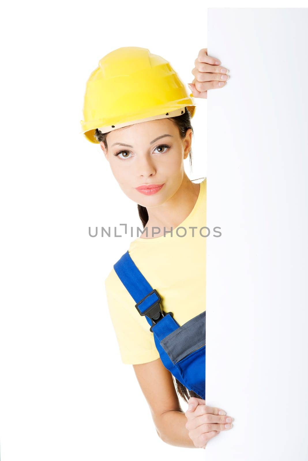 Female construction worker with blank board, isolated on white