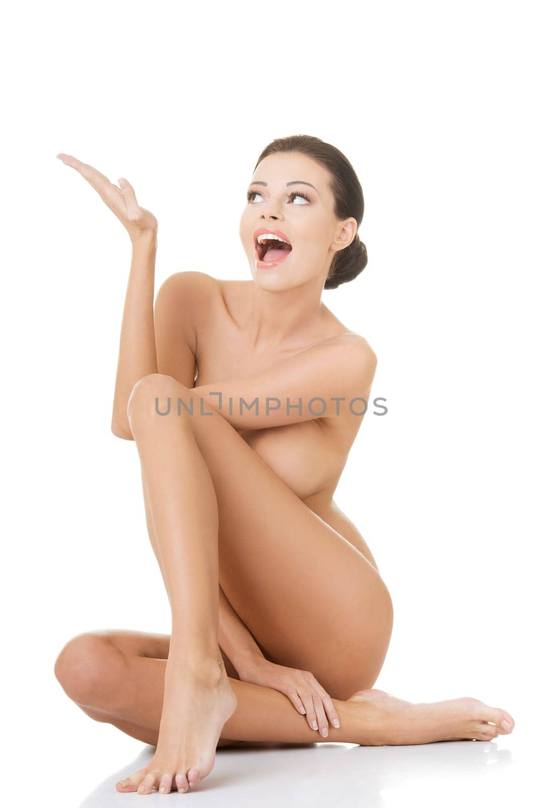 Sexy fit nude woman with healthy clean skin showing on copy space,  isolated on white background