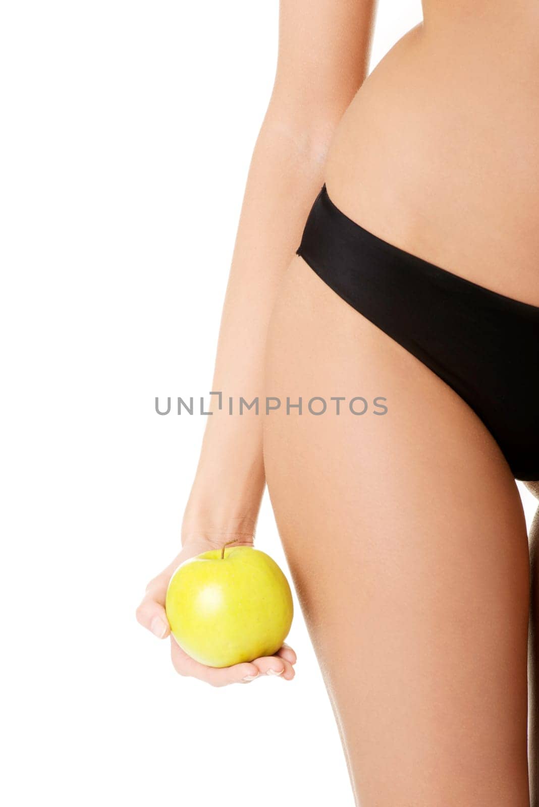 Beautiful fit sensual female body and apple isolated on white background