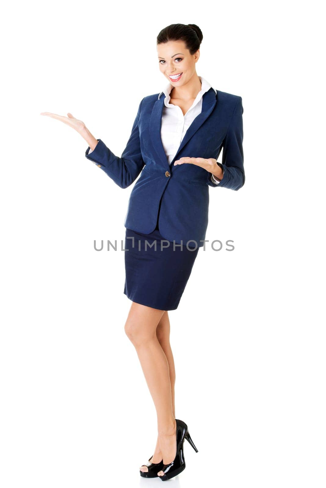 Happy young business woman showing copy space, isolated on white
