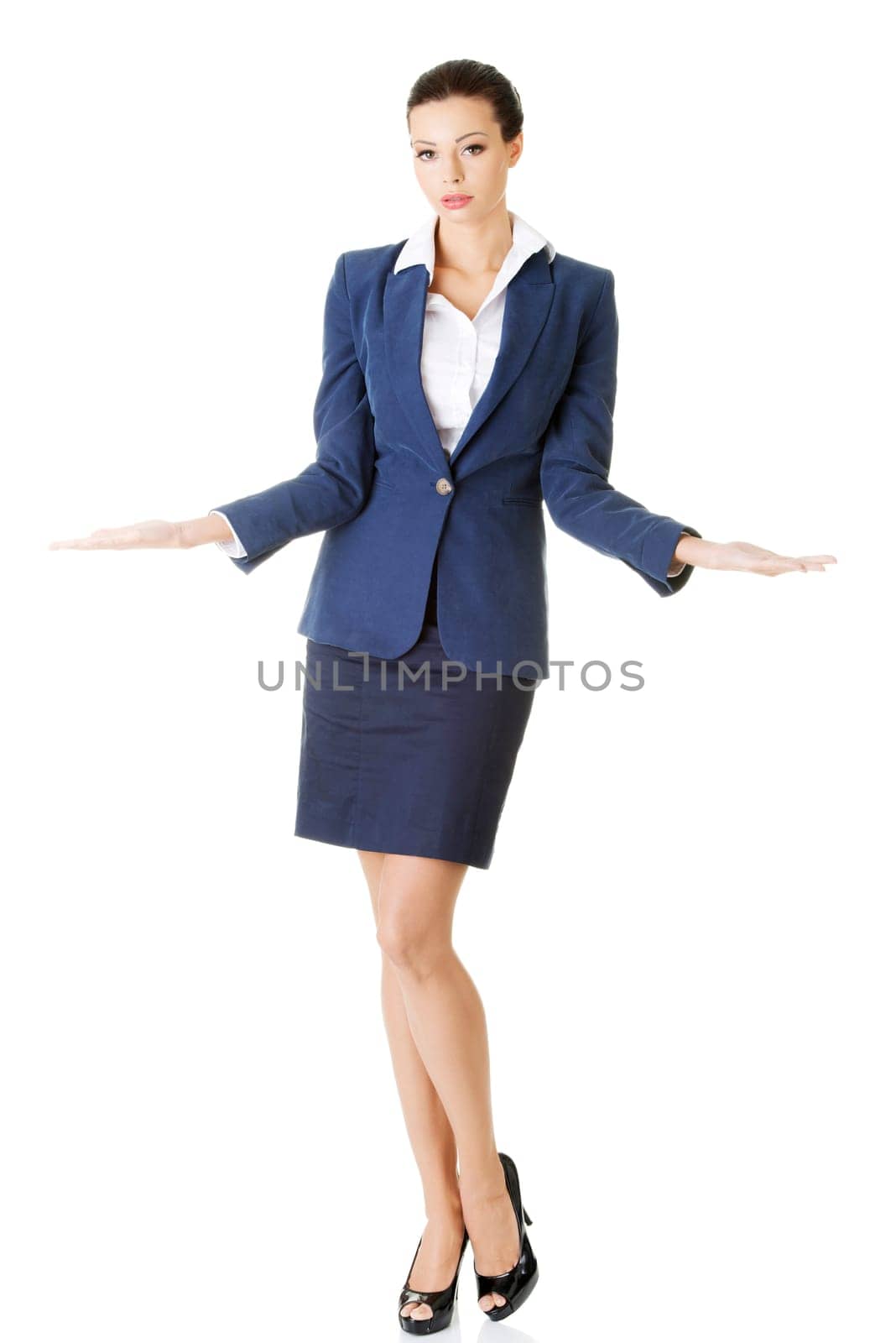 Happy young business woman showing copy space on her palm, isolated on white