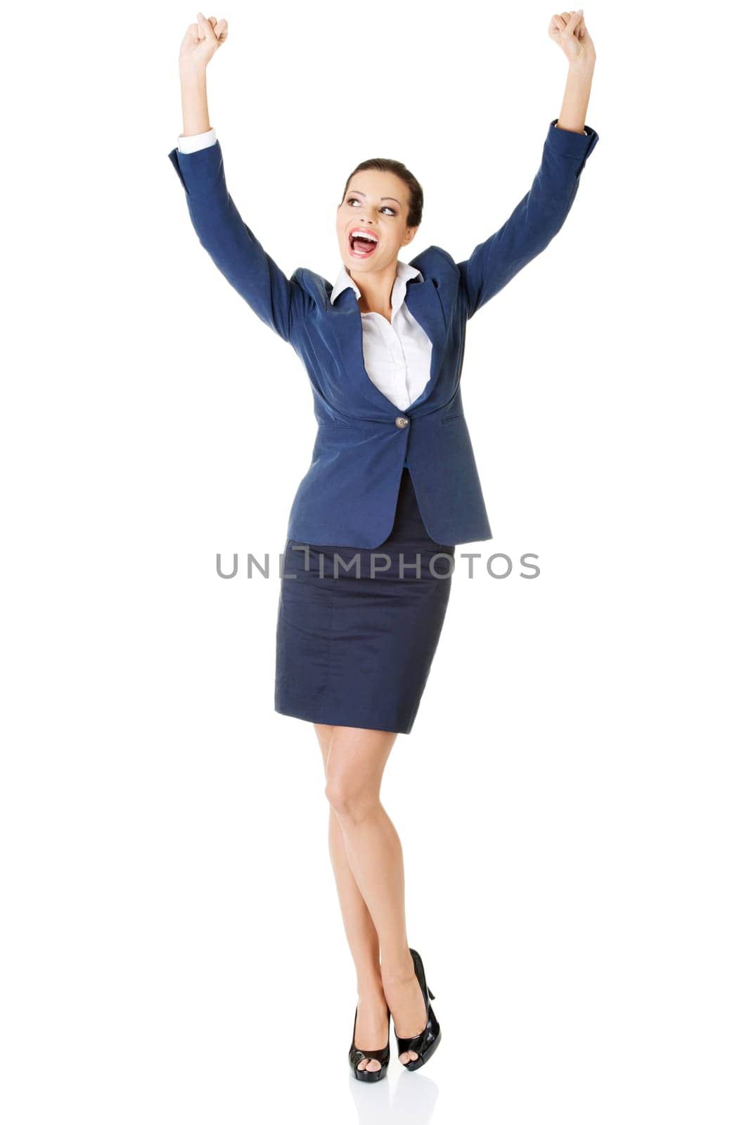 Young happy businesswoman with hands up, isolated on white