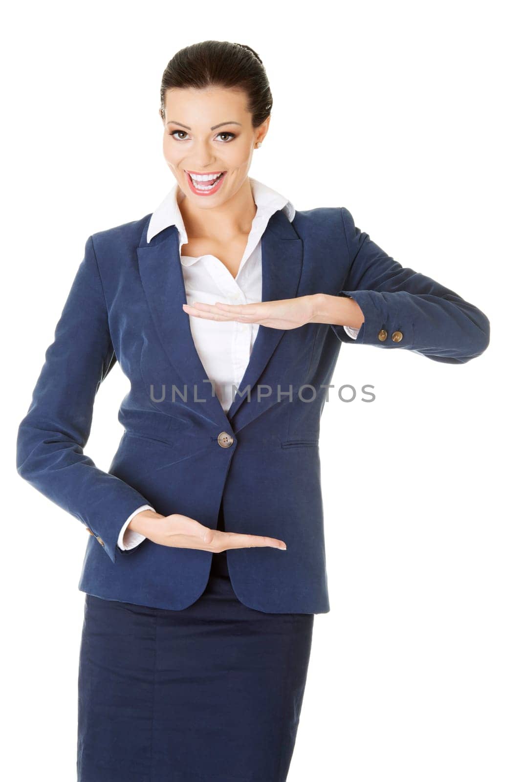 Happy young business woman showing copy space on her palm, isolated on white