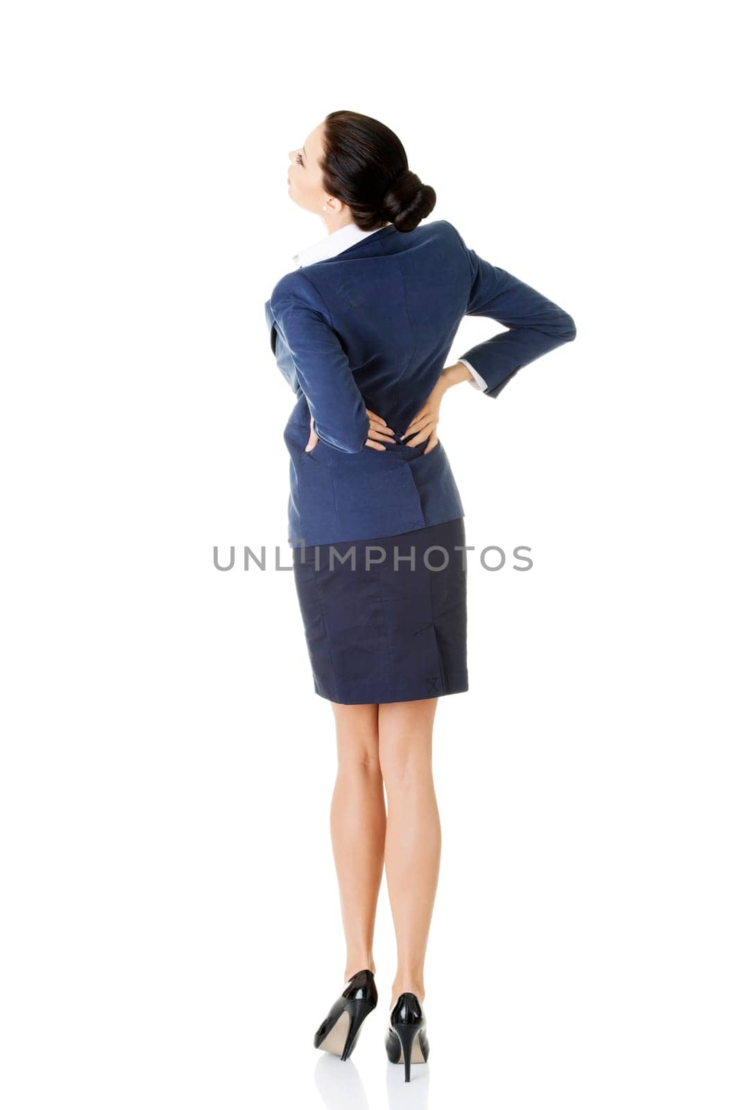 Businesswoman with back ache after long work. Isolated on white