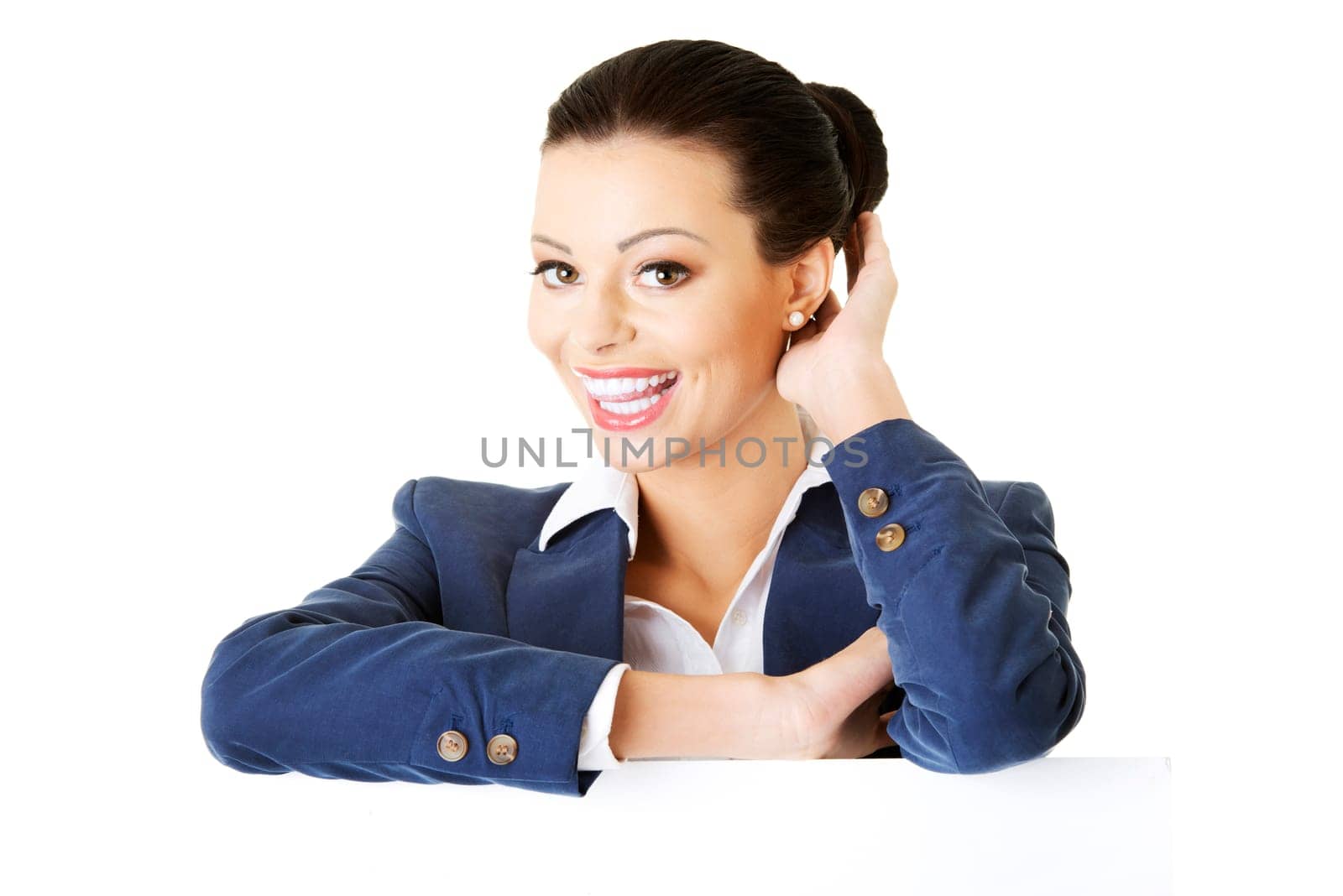 Smiling young business woman showing blank signboard, over white background isolated