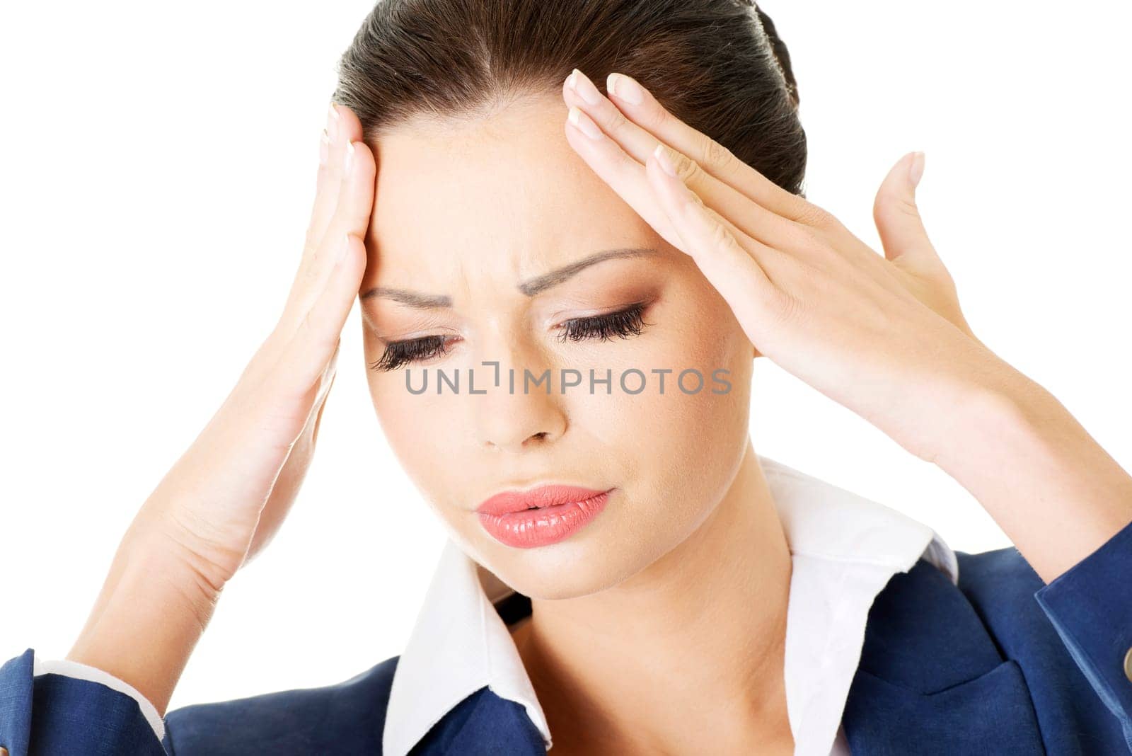 A businesswoman with a headache holding head, isolated on white background
