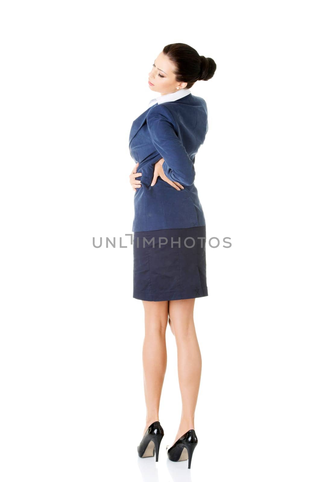 Business woman with back pain after long work. Isolated on white
