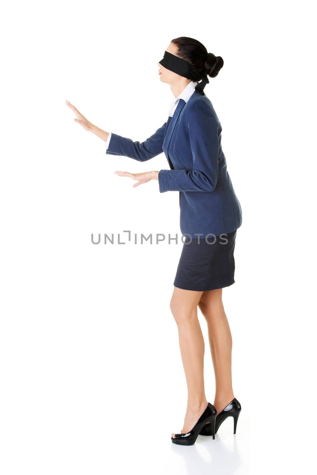 Portrait of a beautiful young blindfold businesswoman, isolated on white